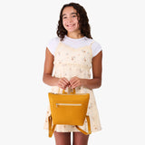 Sunshine | Model wearing a petite square slim leather tote backpack with zipper closure and adjustable straps