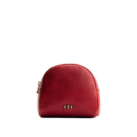Chili Red | Curved top leather pouch with zipper opening, flat base, and three metal tree emblems in front