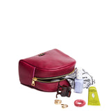 Orchid | Curved top leather pouch with zipper opening, flat base, and three metal tree emblems in front