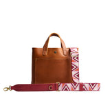 Pink Pony | Adjustable fabric and leather strap with zig zag pattern on a leather tote bag