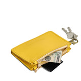 Canary | Leather double zip wallet with keychain clasp and zipper, shown with keys and a dollar bill tucked inside, on a clean white background