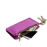 Cattleya | Leather double zip wallet with keychain clasp and zipper, shown with keys and a dollar bill tucked inside, on a clean white background