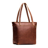 Nutmeg Medium Zipper | Model wearing leather tote bag with riveted straps and exterior key loop
