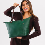 Bacalar Zipper | Model holding large leather tote bag with sturdy bridle handles and front pocket