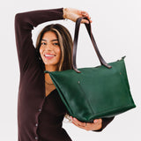 Bacalar Zipper | Model holding large leather tote bag with sturdy bridle handles and front pocket