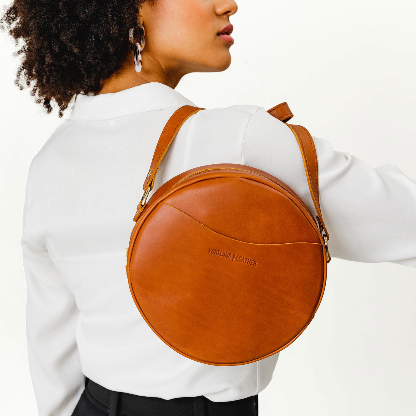 Model carrying large Circle Crossbody Bag in Honey