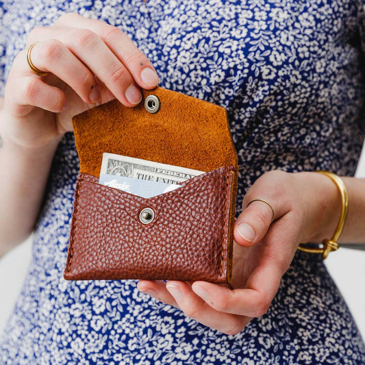 Nutmeg | Model holding small leather envelope card wallet open